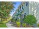 Charming townhomes with landscaped walkways, stone accents, and light-green exteriors at 14501 Damai Ln, Orlando, FL 32821
