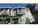 Inviting townhouse featuring charming architectural details and a lush garden entrance at 14501 Damai Ln, Orlando, FL 32821