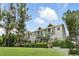 Attractive townhomes feature well-maintained landscaping and multiple windows that flood interiors with natural light at 14501 Damai Ln, Orlando, FL 32821