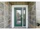 Elegant front door with decorative glass and a secure lock system, enhancing both style and safety at 14501 Damai Ln, Orlando, FL 32821