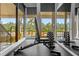 Well-equipped gym featuring weightlifting bench and dumbbell racks with poolside views at 14501 Damai Ln, Orlando, FL 32821
