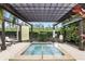 Relaxing hot tub under a pergola in a community setting with lush greenery and serene atmosphere at 14501 Damai Ln, Orlando, FL 32821