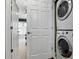 Convenient laundry area features a stacked washer and dryer, maximizing space, with white interior doors at 14501 Damai Ln, Orlando, FL 32821