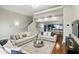 Inviting living room with plush sofas, hardwood floors, and an open layout leading to the modern kitchen at 14501 Damai Ln, Orlando, FL 32821
