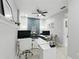 Office with two workstations, a modern ceiling fan, and tile floors at 14501 Damai Ln, Orlando, FL 32821