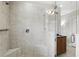 Modern tiled shower with glass door, built-in bench, and sleek fixtures at 14501 Damai Ln, Orlando, FL 32821