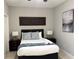 Cozy bedroom with decorative headboard, bedside tables, and a relaxing atmosphere at 14513 Damai Ln, Orlando, FL 32821