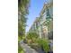 Exterior view of condo buildings featuring well-maintained landscaping and neutral-colored facades with balconies at 14513 Damai Ln, Orlando, FL 32821
