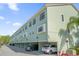 Exterior view of condo buildings featuring covered parking, neutral-colored facades, and a well-lit exterior at 14513 Damai Ln, Orlando, FL 32821