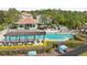 Aerial view showcasing a community pool with chairs, umbrellas and a cabana at 14513 Damai Ln, Orlando, FL 32821