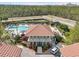 Aerial view showcasing a community pool with a cabana, a pool and outdoor cooking area at 14513 Damai Ln, Orlando, FL 32821