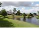 Tranquil backyard view overlooking a pond, mature trees and neighboring homes at 1486 Farrindon Cir, Lake Mary, FL 32746