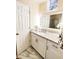 Bright bathroom featuring white vanity with granite countertop, framed mirror, and white cabinets at 1486 Farrindon Cir, Lake Mary, FL 32746