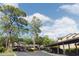 Carport parking spaces beneath mature shady trees in the community with blue skies at 1486 Farrindon Cir, Lake Mary, FL 32746