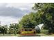Well-maintained community sign surrounded by flowers and hedges under a cloudy sky at 1486 Farrindon Cir, Lake Mary, FL 32746
