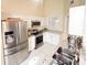 Bright kitchen featuring stainless steel appliances, granite countertops, and white cabinets at 1486 Farrindon Cir, Lake Mary, FL 32746