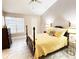 Bright bedroom features neutral walls, vaulted ceiling, tile floor, and a four-poster bed at 1486 Farrindon Cir, Lake Mary, FL 32746