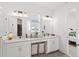 Bright bathroom features double vanity, a glass-enclosed shower, and a view of exterior and interior of the home at 15444 Lebeau Loop, Winter Garden, FL 34787