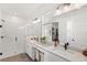 Bright bathroom features double vanity, a glass-enclosed shower, and a view into a spacious walk-in closet at 15444 Lebeau Loop, Winter Garden, FL 34787