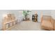 Bright Bedroom with a crib, storage shelves, plush toys, and a potted plant at 15444 Lebeau Loop, Winter Garden, FL 34787