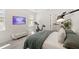 Well-lit bedroom with a modern exercise bike, TV, and cozy decor, creating a relaxing and functional space at 15444 Lebeau Loop, Winter Garden, FL 34787