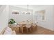 Dining area with a modern wooden table, plush chairs, stylish decor, and natural lighting at 15444 Lebeau Loop, Winter Garden, FL 34787