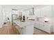 Bright, open kitchen with stainless steel appliances, quartz countertops, and a large center island with seating at 15444 Lebeau Loop, Winter Garden, FL 34787