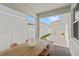 Covered patio with brick flooring and a wooden table with colorful chairs at 15444 Lebeau Loop, Winter Garden, FL 34787