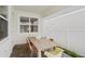 Covered patio with brick flooring and a wooden table with colorful chairs at 15444 Lebeau Loop, Winter Garden, FL 34787