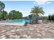 Community pool with a large deck area, sun loungers and nearby seating at 15444 Lebeau Loop, Winter Garden, FL 34787