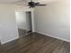Clean bedroom showcasing a mirrored closet, vinyl floors, and a modern ceiling fan at 1750 Mitten Ter, Deltona, FL 32738