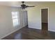 This bedroom has light walls, vinyl flooring, a ceiling fan, and a window for natural light at 1750 Mitten Ter, Deltona, FL 32738