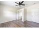 Neutral bedroom featuring wood-look flooring, a ceiling fan, and a closet with sliding doors at 1750 Mitten Ter, Deltona, FL 32738
