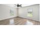 Bright bedroom featuring wood-look flooring and large windows with bright natural light at 1750 Mitten Ter, Deltona, FL 32738