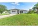Charming home with a well-manicured lawn, a paved driveway, and a welcoming facade at 1750 Mitten Ter, Deltona, FL 32738