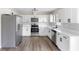 Well-lit kitchen featuring stainless steel appliances, white cabinets, and sleek countertops at 1750 Mitten Ter, Deltona, FL 32738