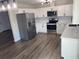 Modern kitchen with white cabinets, stainless steel appliances, and stylish backsplash at 1750 Mitten Ter, Deltona, FL 32738