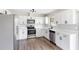 Modern kitchen featuring stainless appliances, bright white cabinets, and sleek countertops at 1750 Mitten Ter, Deltona, FL 32738