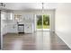 Bright eat-in kitchen with stainless appliances, white cabinets, and sliding glass doors to the backyard at 1750 Mitten Ter, Deltona, FL 32738
