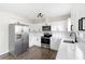 Well-lit kitchen featuring stainless steel appliances, white cabinets, and sleek countertops at 1750 Mitten Ter, Deltona, FL 32738