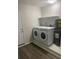 Bright laundry room with washer, dryer, storage shelf, and modern flooring at 1750 Mitten Ter, Deltona, FL 32738