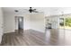 Open-concept living space with wood-look flooring, seamlessly flowing into the kitchen area at 1750 Mitten Ter, Deltona, FL 32738