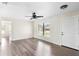 Bright living area with modern ceiling fan and wood-look flooring, enhanced by natural light at 1750 Mitten Ter, Deltona, FL 32738