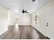 Open living area featuring wood-look flooring, a ceiling fan, and plenty of space for entertaining at 1750 Mitten Ter, Deltona, FL 32738