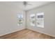 Neutral bedroom offering three windows, wood-look floors, a ceiling fan and white trim at 181 Longview Ave, Kissimmee, FL 34747