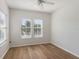 Bright bedroom has two large windows with wood-look floors and neutral colors at 181 Longview Ave, Kissimmee, FL 34747