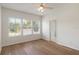 Spacious bedroom with wood floors, large windows, and a door to the bathroom at 181 Longview Ave, Kissimmee, FL 34747