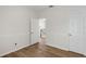Bright bedroom with wood-look floors, neutral paint, and white trim and doors at 181 Longview Ave, Kissimmee, FL 34747