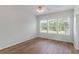 Bright bedroom with hardwood floors and plenty of natural light from three large windows at 181 Longview Ave, Kissimmee, FL 34747