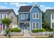 Charming two-story blue home with a inviting front porch and white picket fence at 181 Longview Ave, Kissimmee, FL 34747